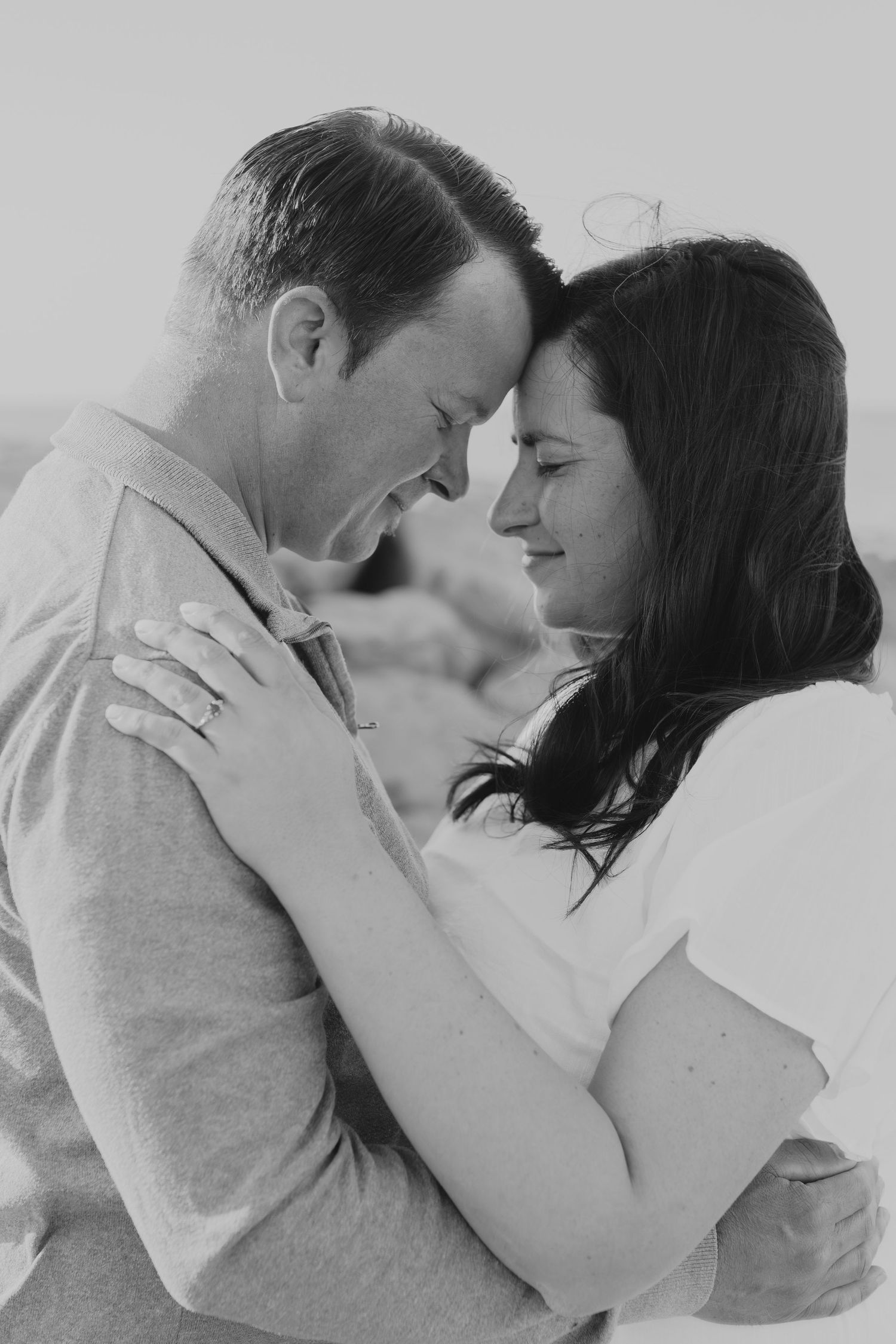 Romantic couple sharing intimate moments in black and white photography sequence.