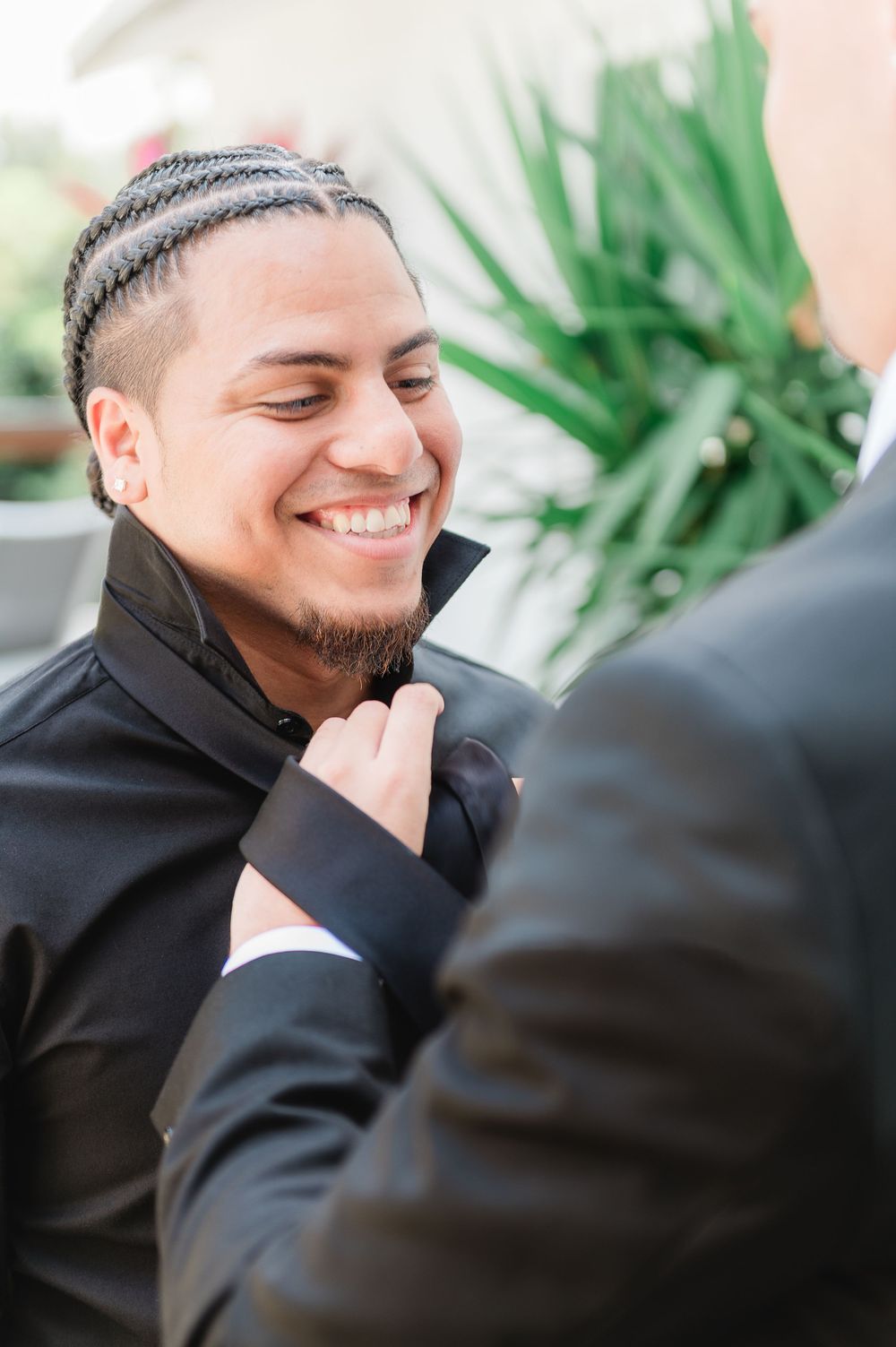A series of candid shots showing genuine emotional expressions and smiles in formal black attire.