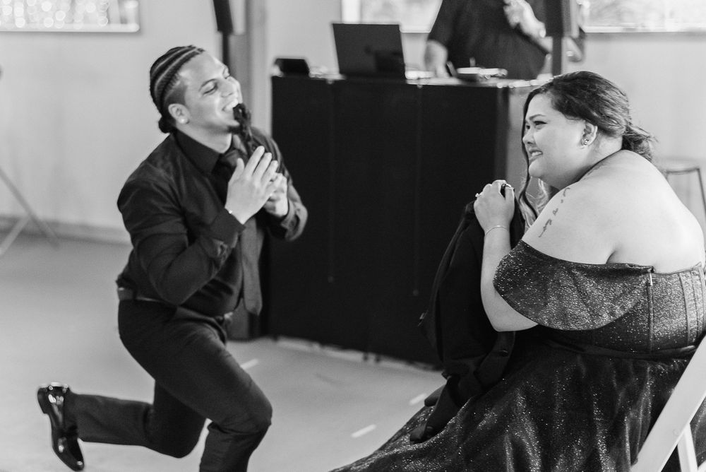 A dramatic black and white photo of theatrical performers during a rehearsal session with a piano in the background.