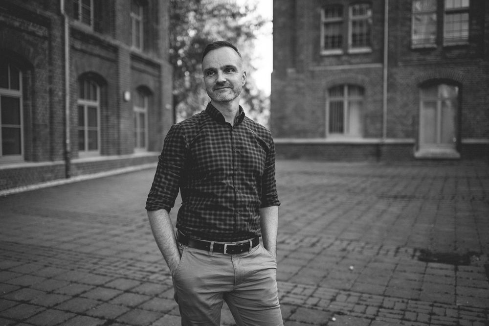 Vintage black and white composite photo showing multiple poses of someone in plaid shirt and casual attire outdoors.