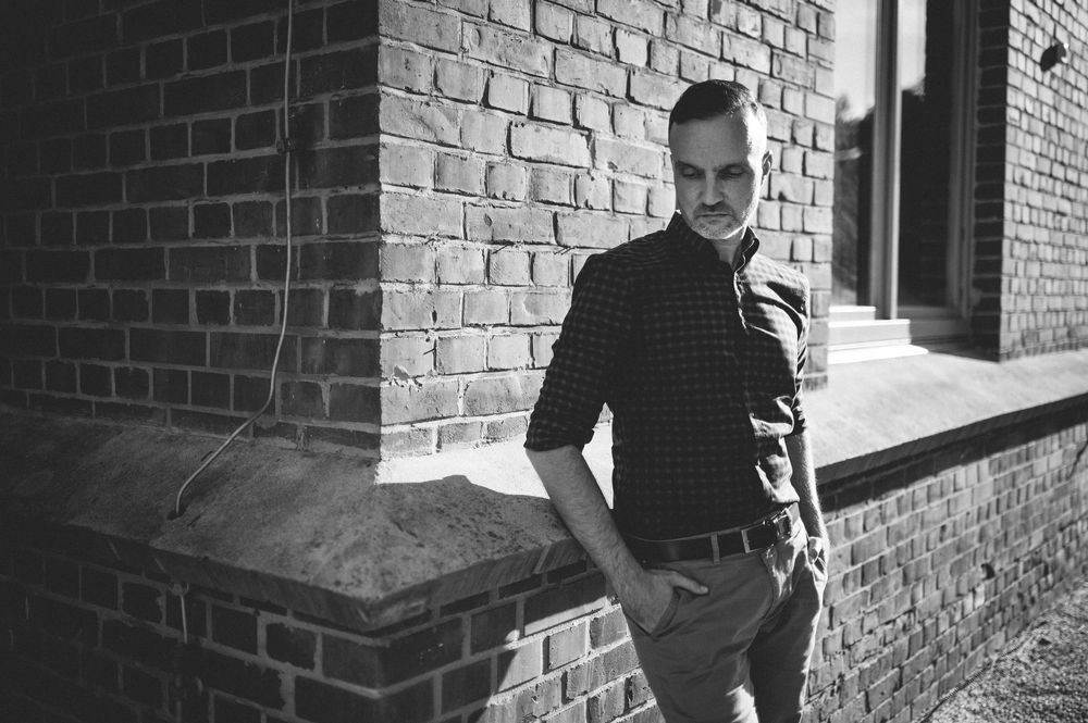 An old black and white sequence of brick wall photos showing shadows, urban textures, and architectural details.