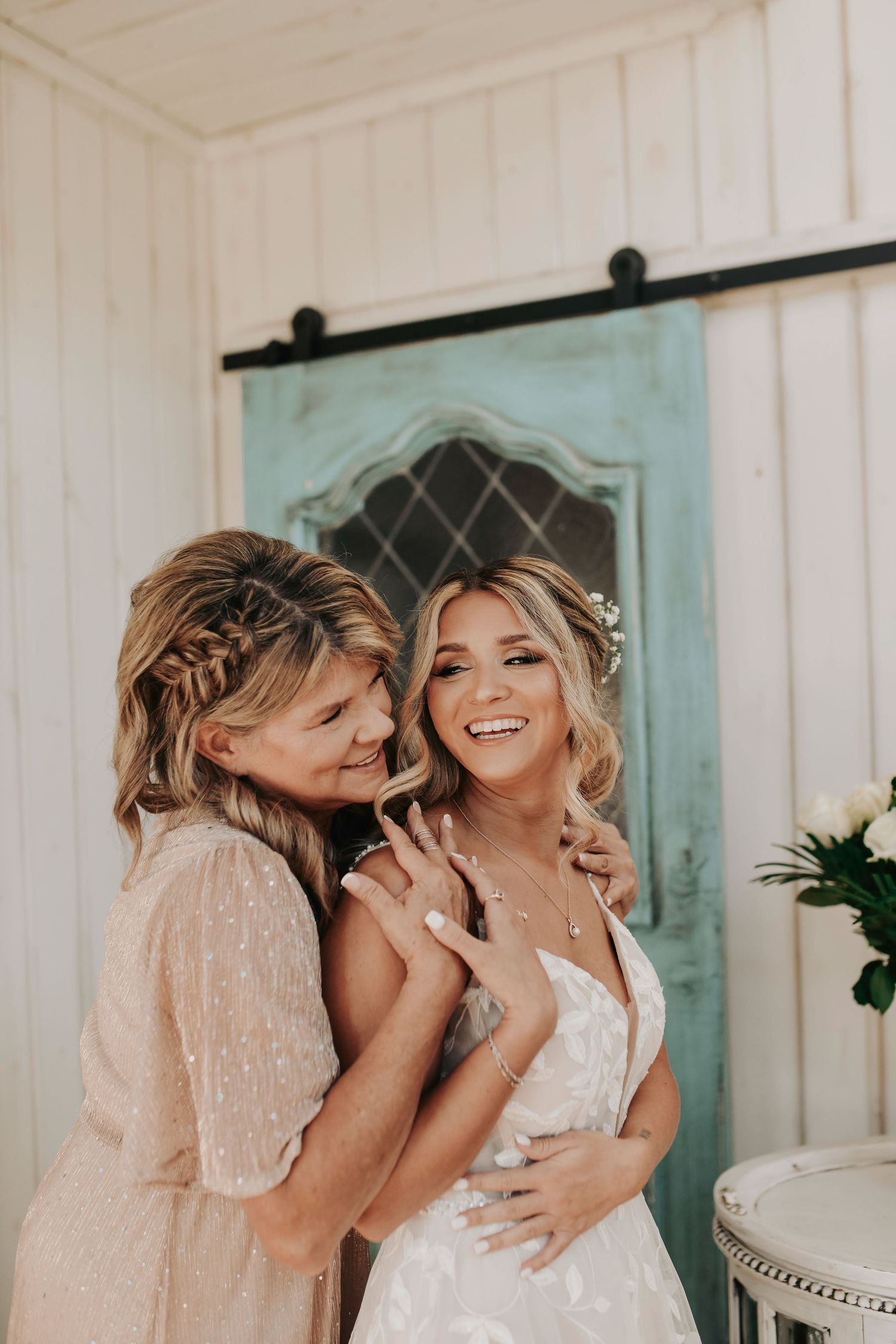 Tender moment between bride and mother on wedding morning