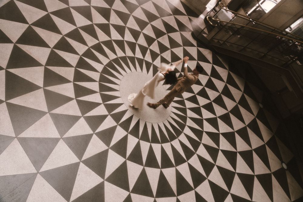 Black and white geometric patterns form a striking circular design on a dark floor or surface.
