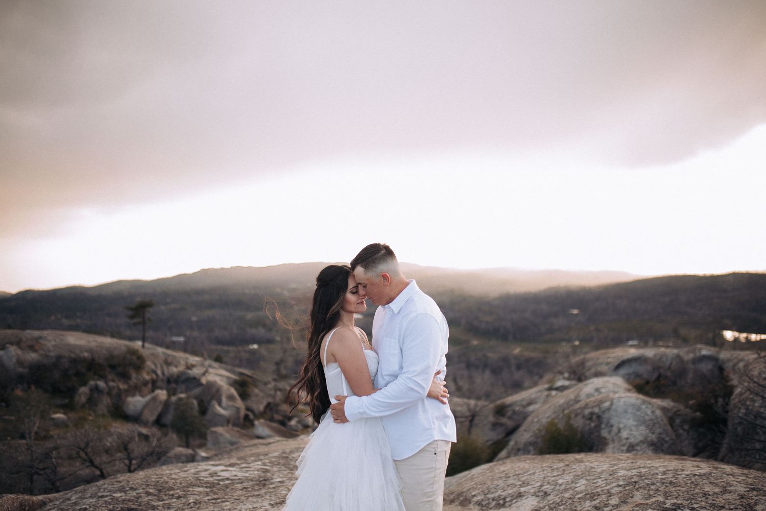 Couple embracing during an outdoor engagement session in North Idaho