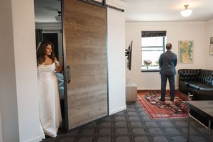 Modern farmhouse style home interior with sliding barn doors, wood accent walls, and hardwood floors.