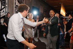 Energetic dance party with people enjoying themselves at an indoor reception venue.