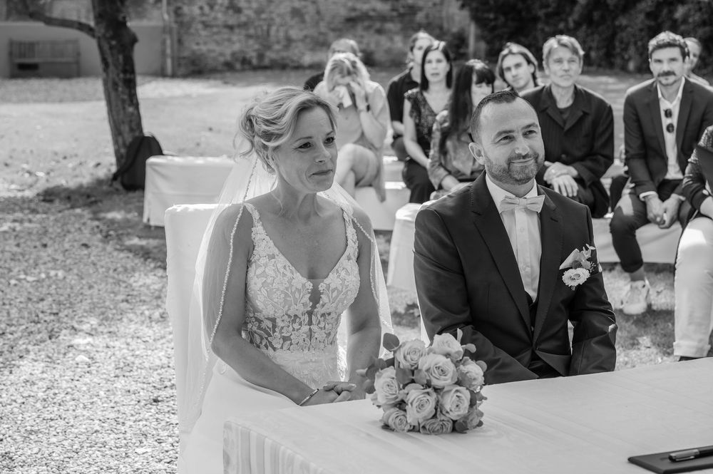 Wedding guests laughing and enjoying themselves during an outdoor reception celebration.