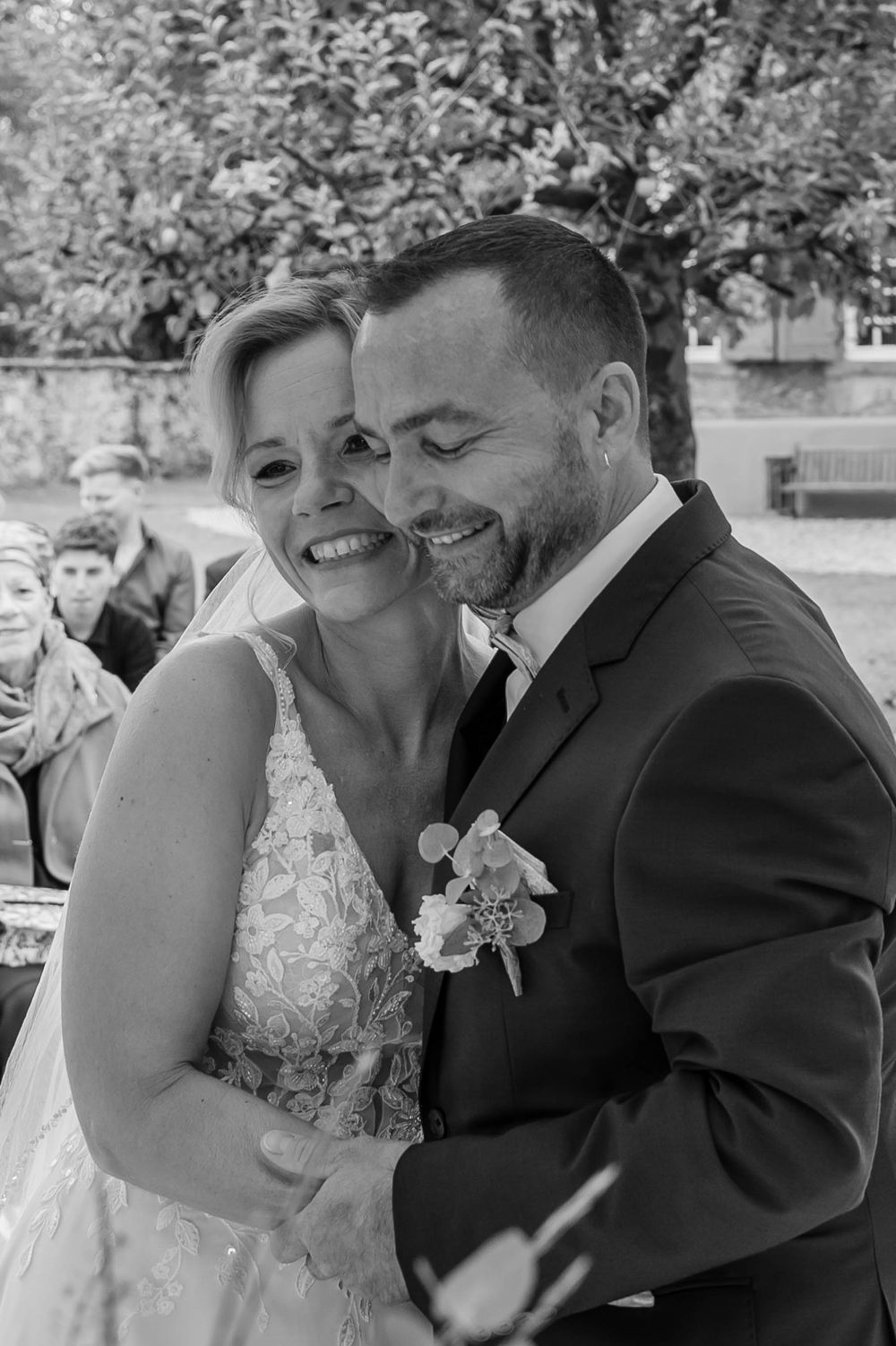 A romantic black and white photo series of a couple sharing intimate moments on their wedding day.