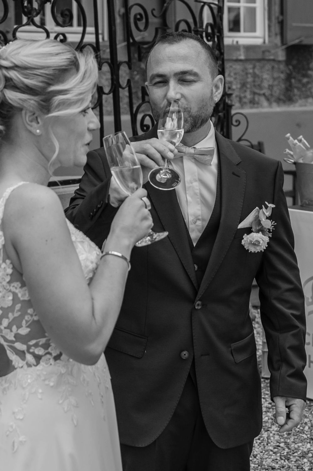 Black and white wedding photos show bride and groom sharing intimate moments during outdoor ceremony.