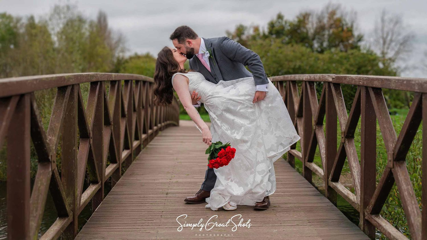 A bride and groom perform a 'dip' at Barton Marina