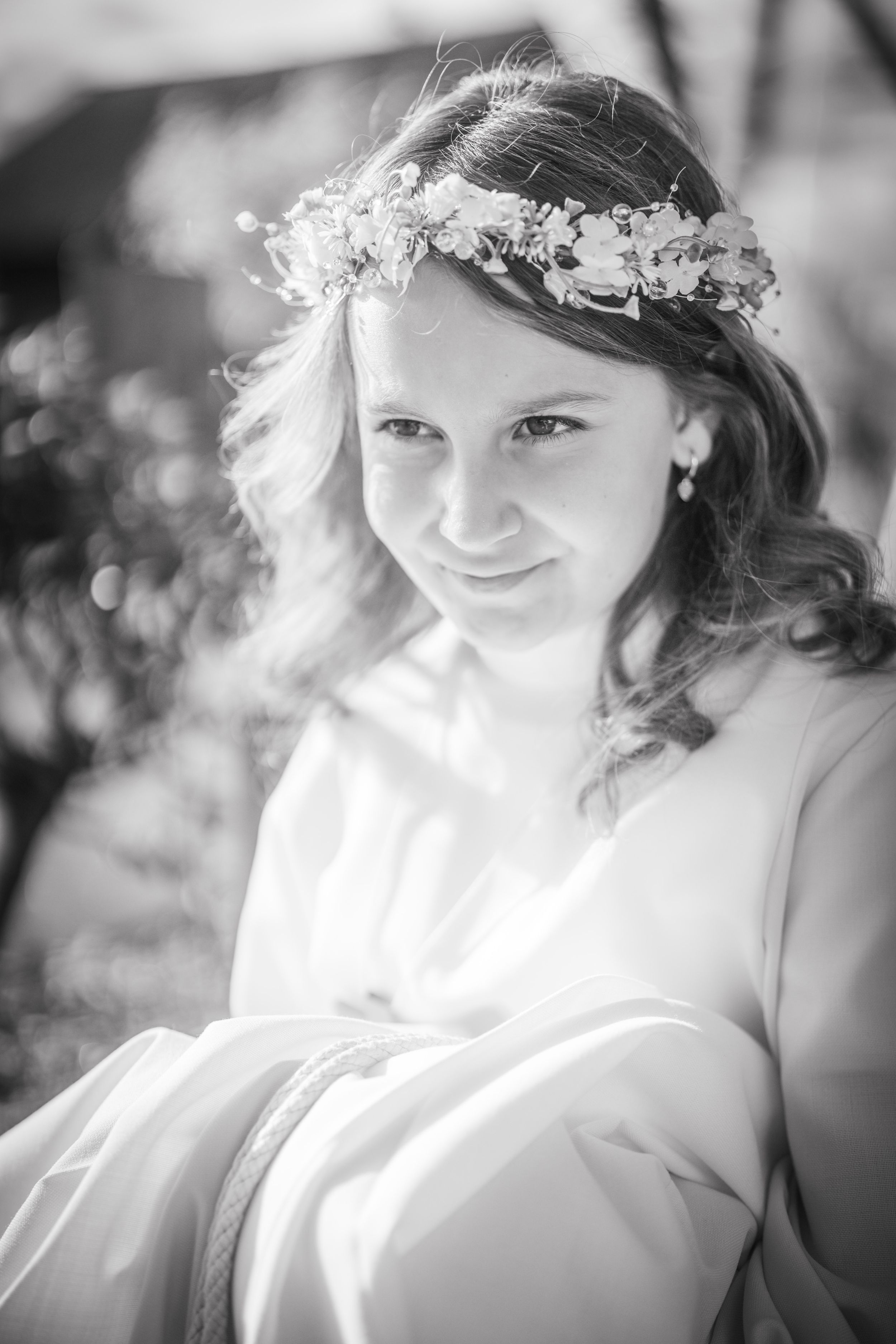 Black and white wedding portrait series showing romantic close-up shots with delicate floral crown details.