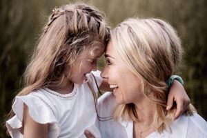 Two people in white outfits share intimate moments across multiple photos with soft natural lighting.