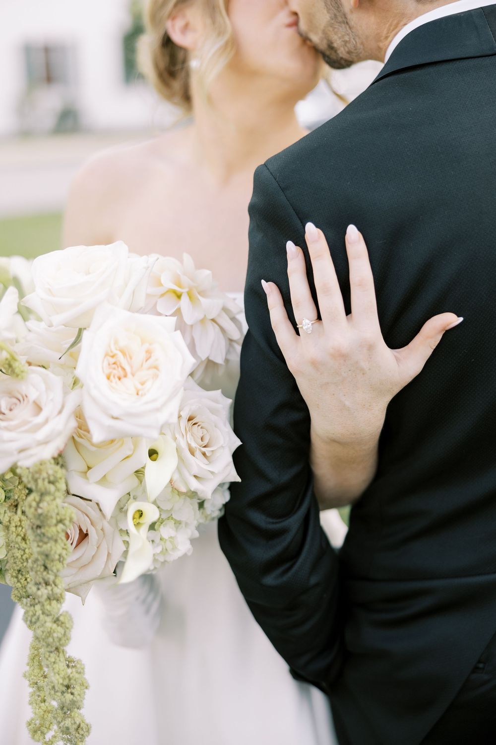 Black and white wedding photo collection showing intimate moments with white roses and formal attire.