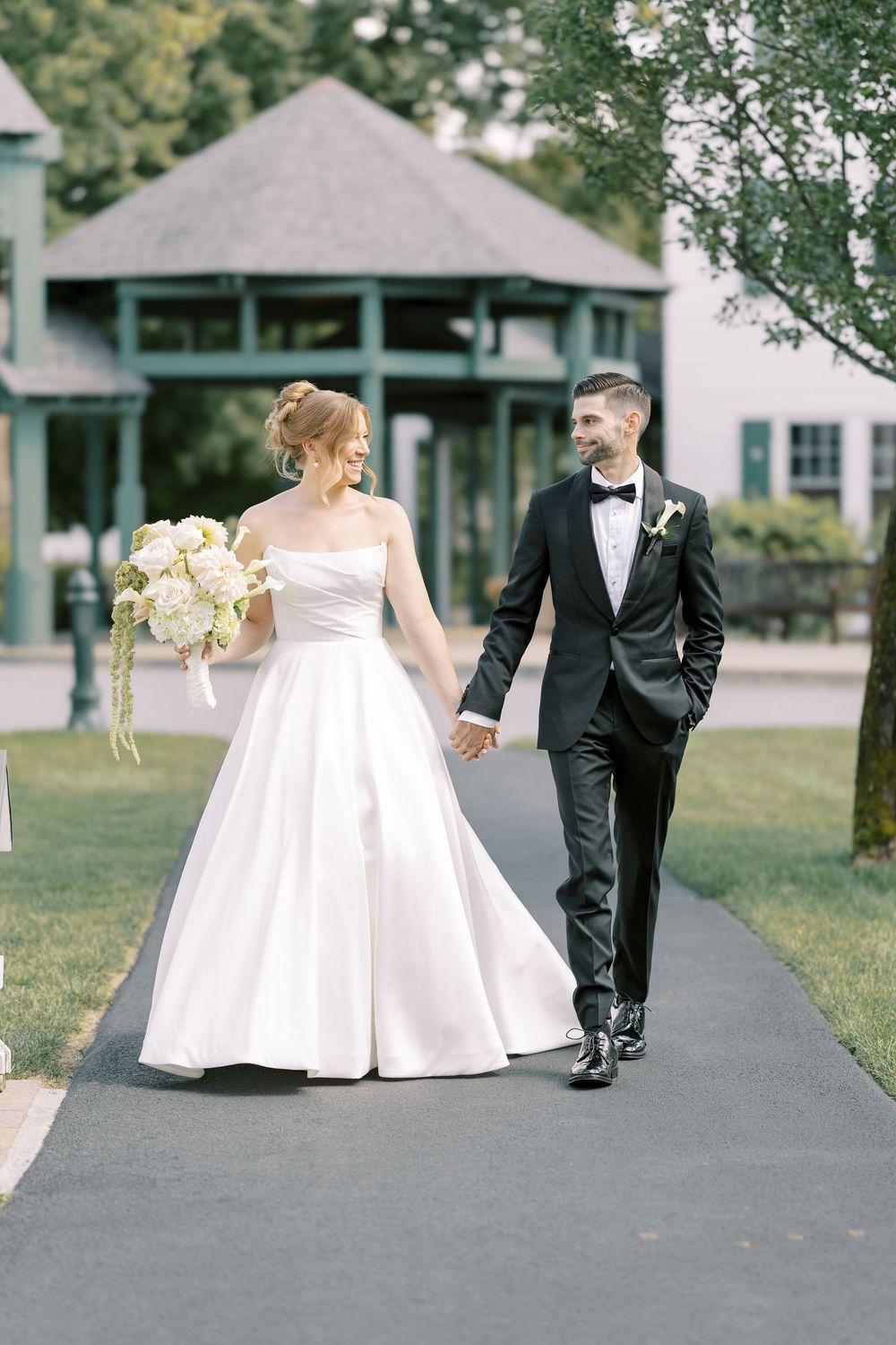 Newlywed couple walking together on a paved pathway in formal wedding attire, captured in a series of photos.