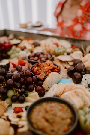Close-up of an elegant wedding reception charcuterie board with grapes, meats, and appetizers. christchurch wedding photography