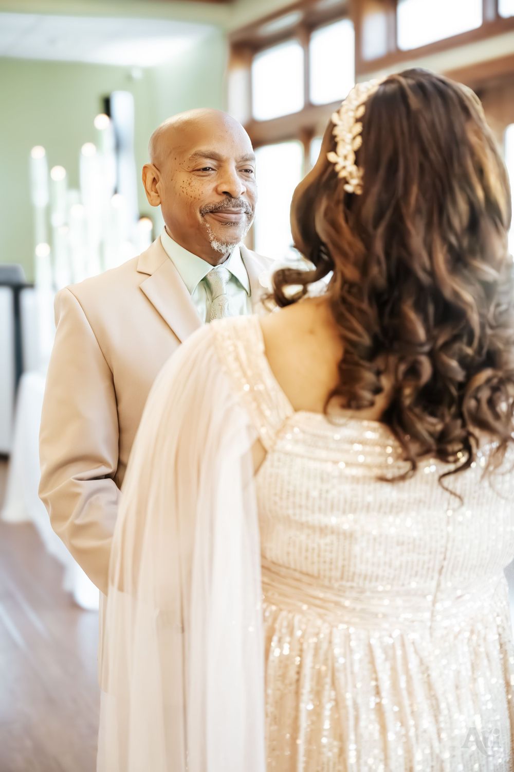An intimate wedding portrait showing pure joy between the couple in light colored formal attire.