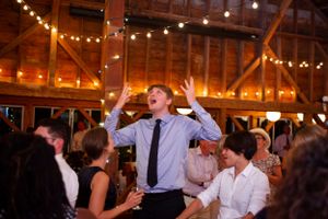 Wedding guests dance together during the reception