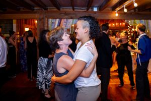 Wedding guests dance together during the reception
