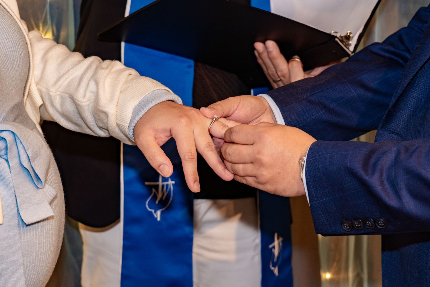 Business people in formal attire exchanging handshakes in a professional office setting.