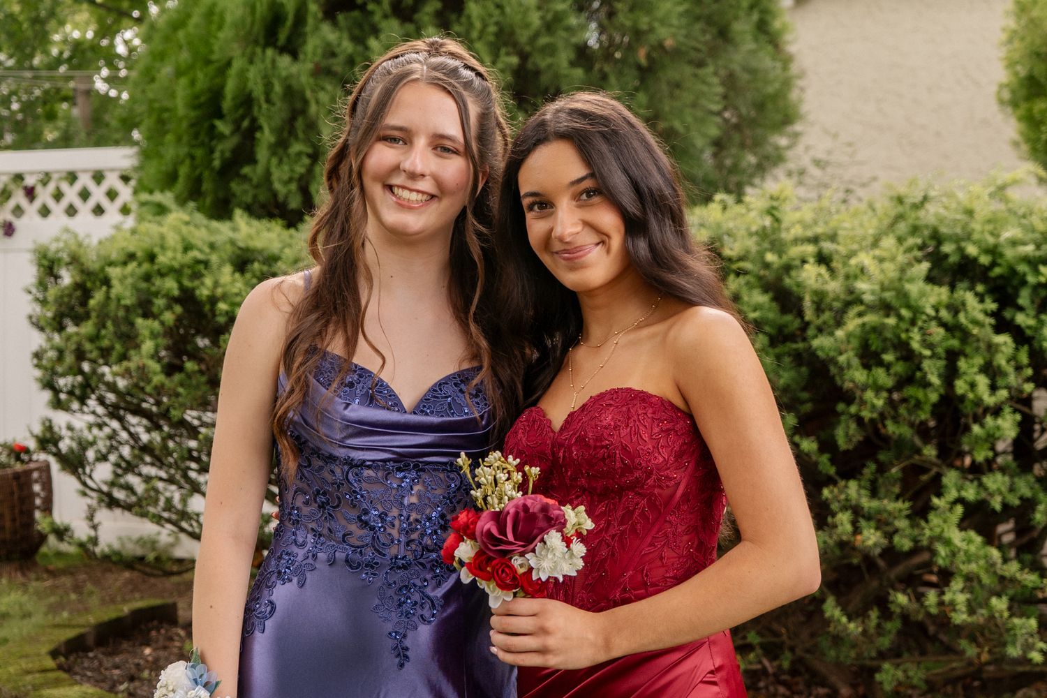 Group photo of people in formal dresses standing together outdoors.