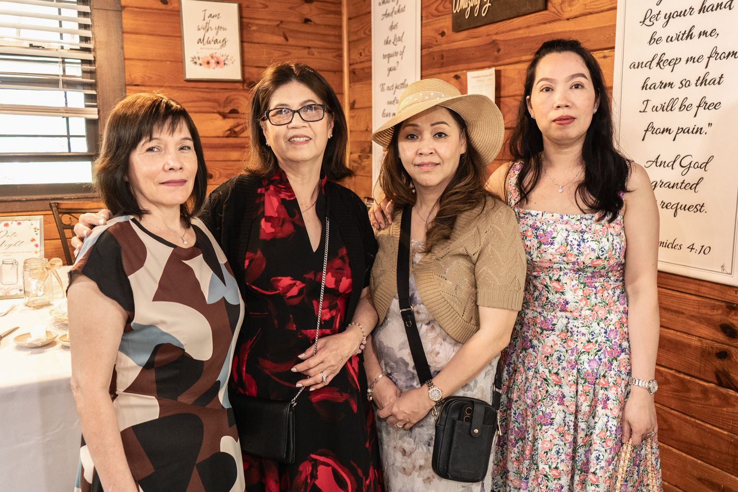 Group gathering inside a wooden cabin with inspirational quotes on the walls.