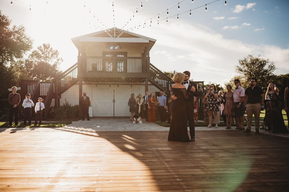 Sunset celebration on outdoor venue deck with guests watching.