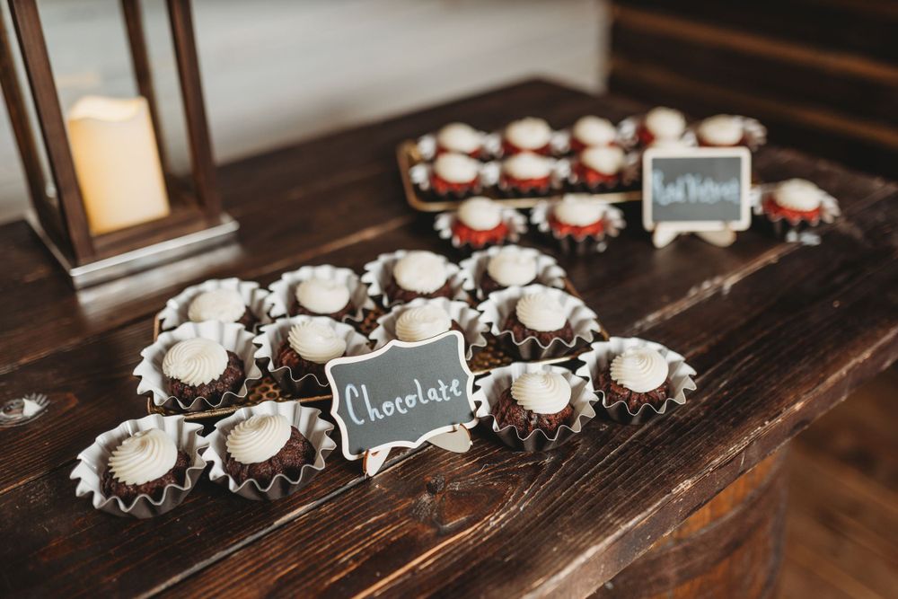 Chocolate desserts with small chalkboard signs displayed on wooden table.