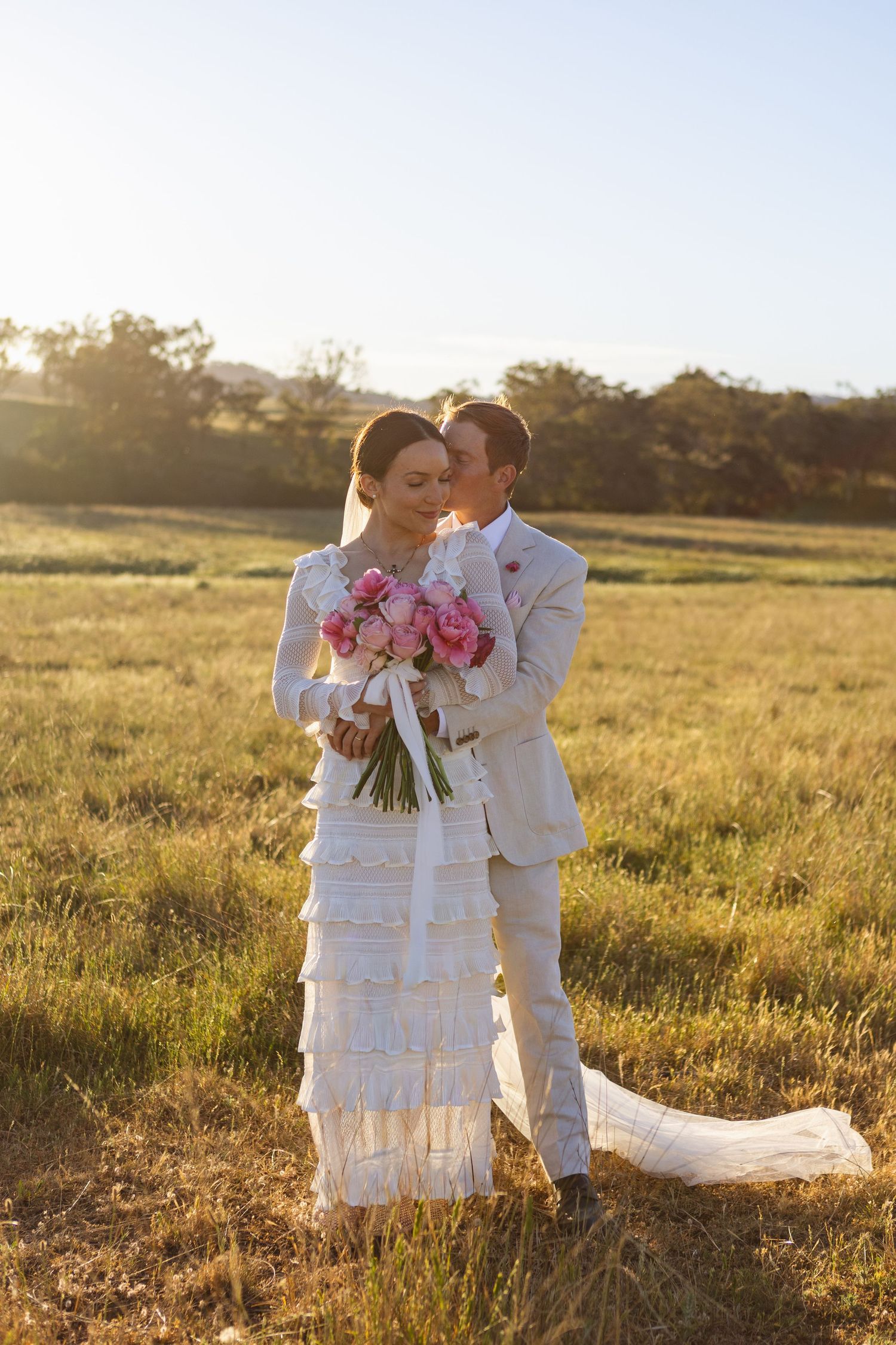 Bride and groom hugging from behind at Scone NSW Country wedding