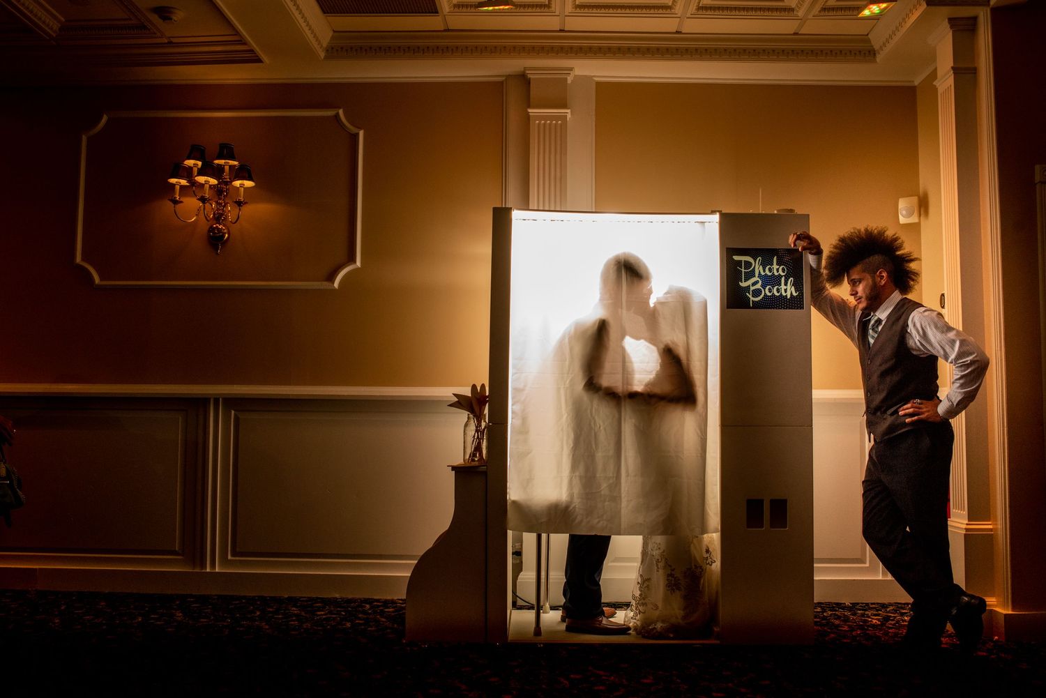 A silhouette behind a translucent screen creates a dramatic wedding photography moment.