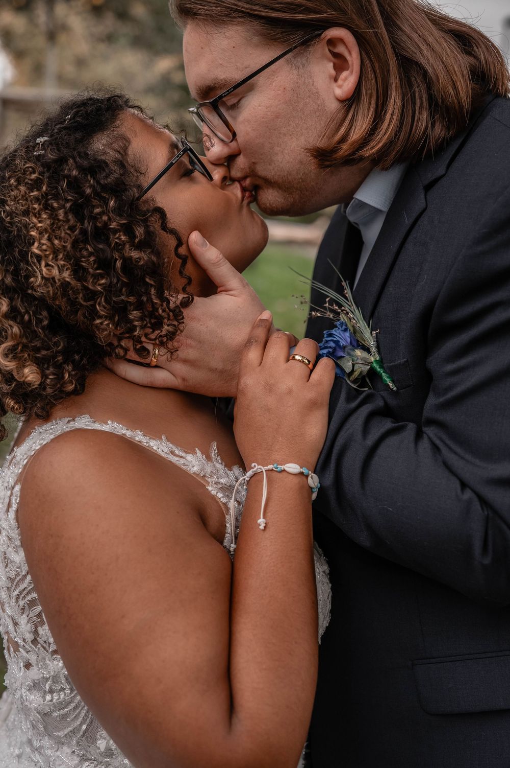 A tender moment between a couple in wedding attire sharing an intimate embrace during their special day.