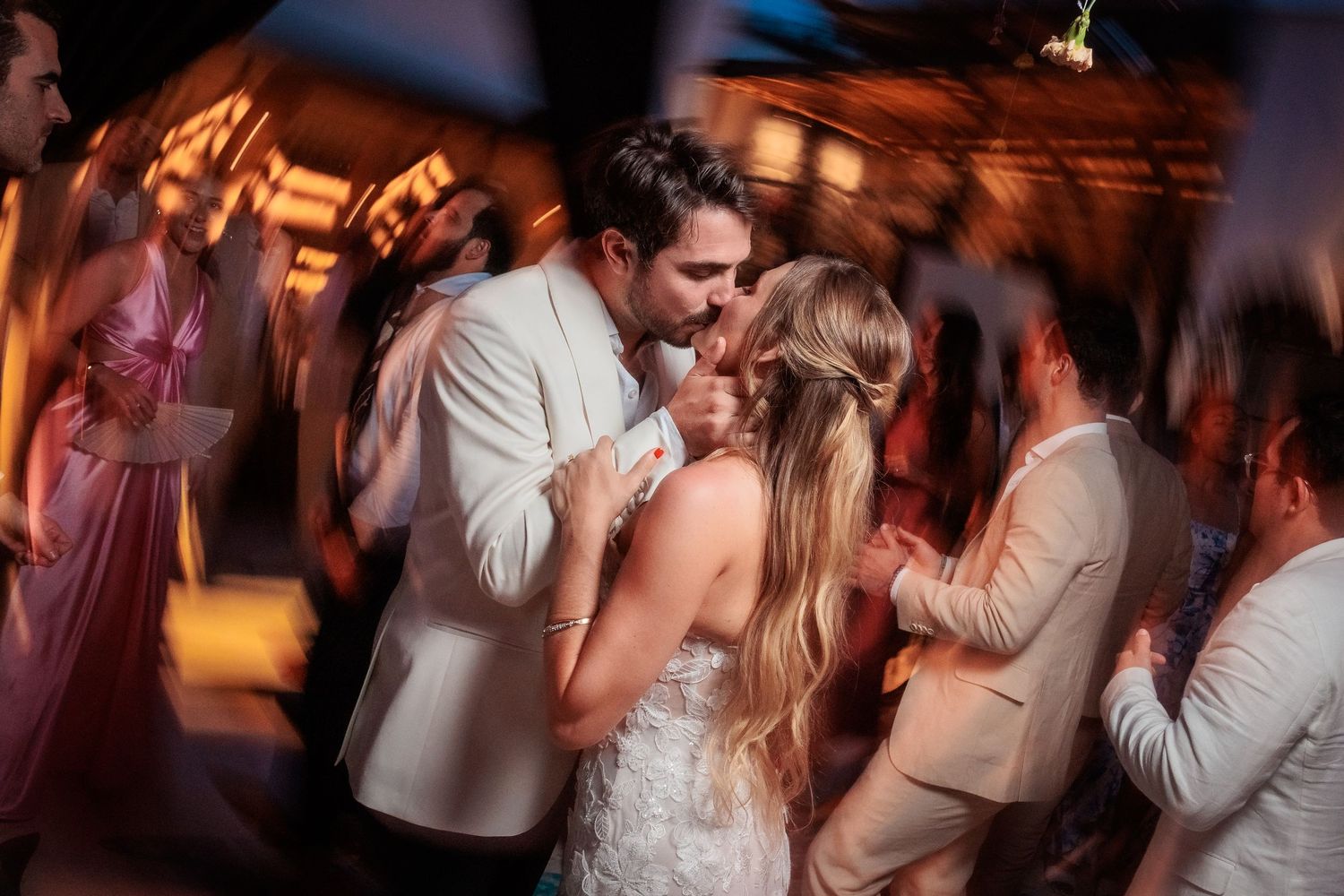 Dance floor moments captured in motion blur during an evening celebration.