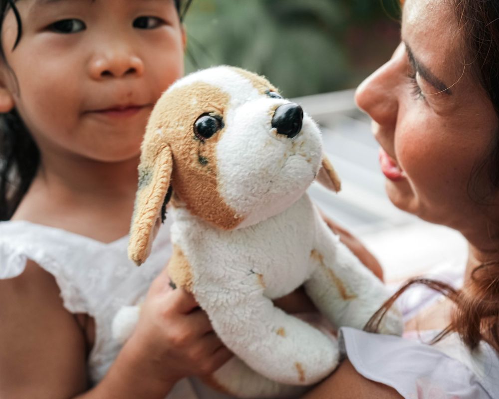 A sequence of photos showing a plush toy dog being kissed and cuddled.