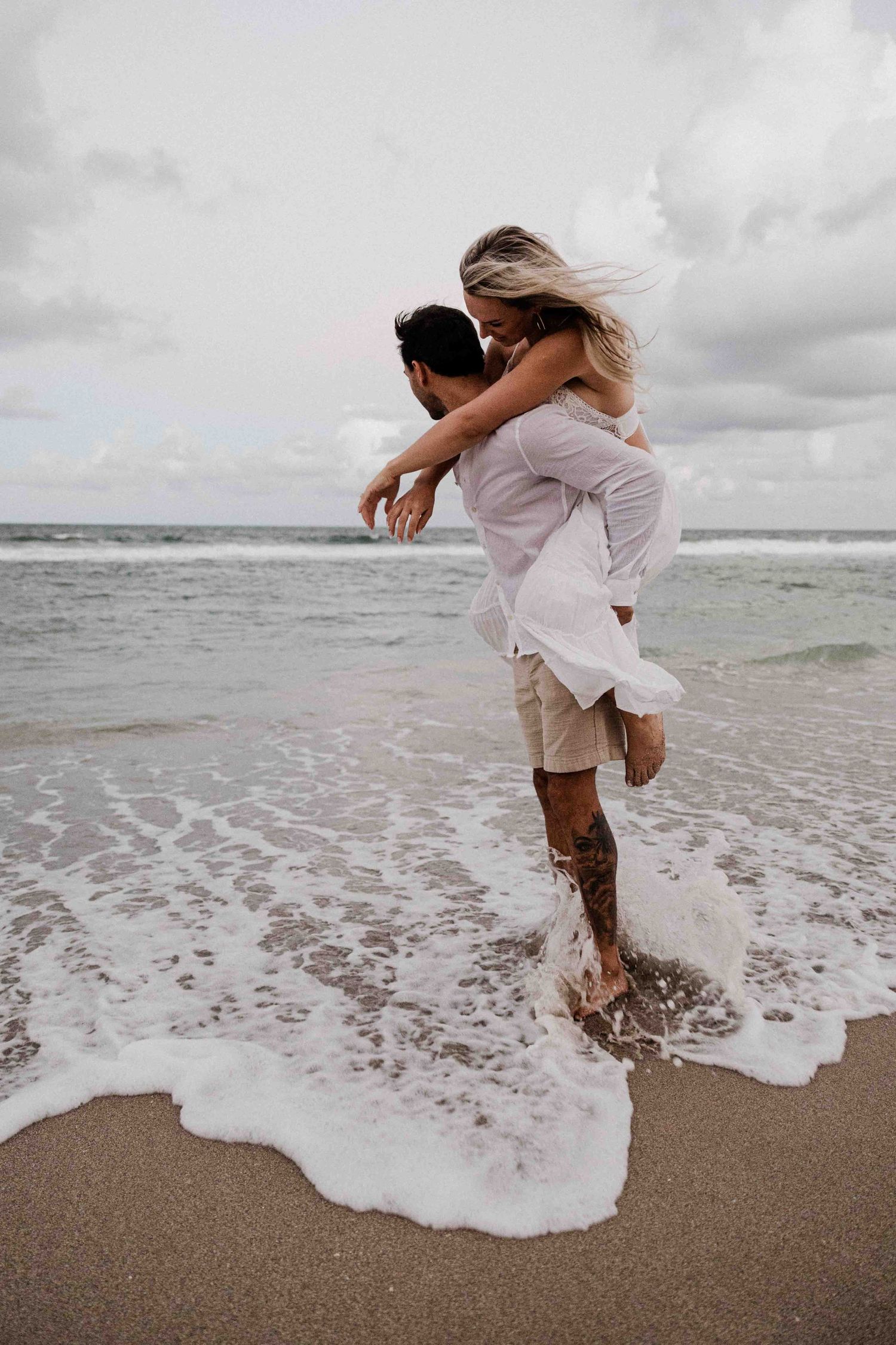 A candid, documentary, film-style wedding photo at Jupiter Beach during sunset with fashion-forward that is calm, tranquil, serene, peaceful