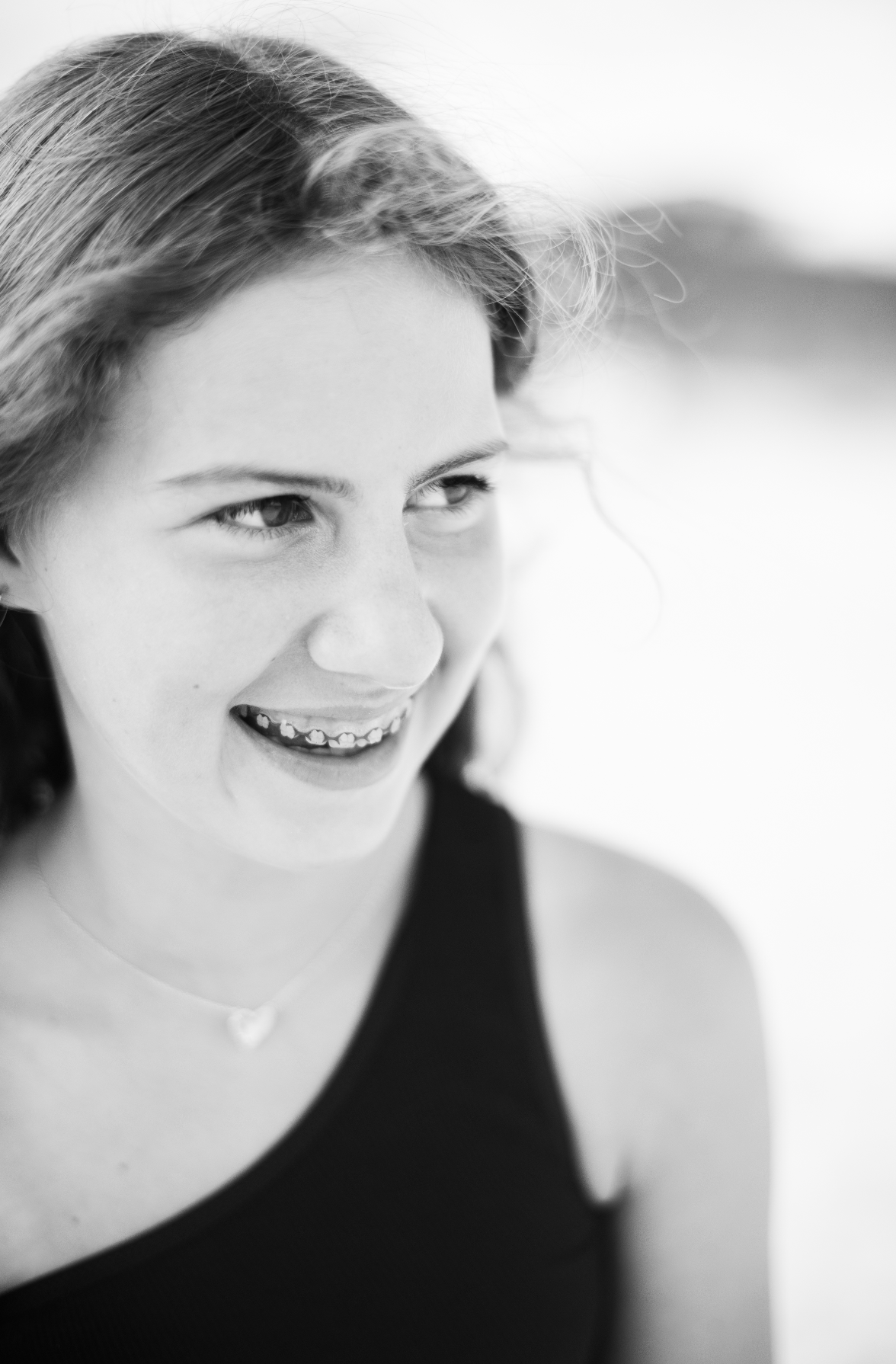 Black and white portrait series showing a person in a dark top expressing different emotions and angles.