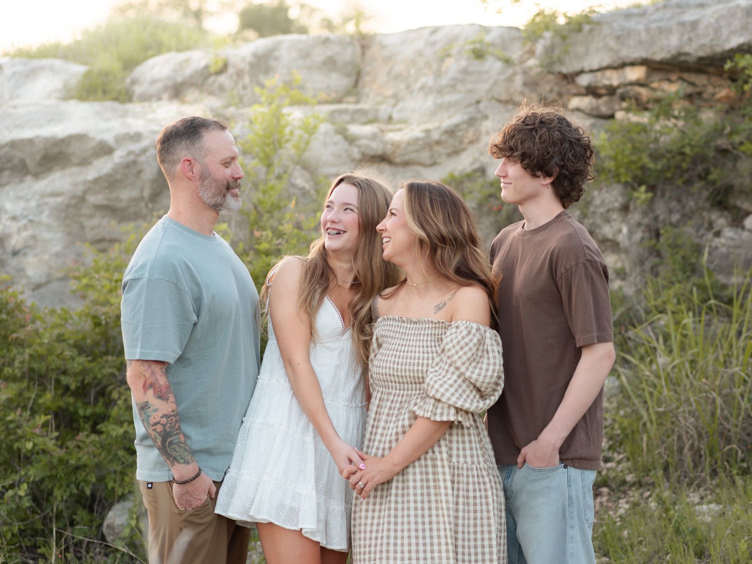 Parents holding smiling baby during golden hour session at Nolan Creek in Belton Texas
