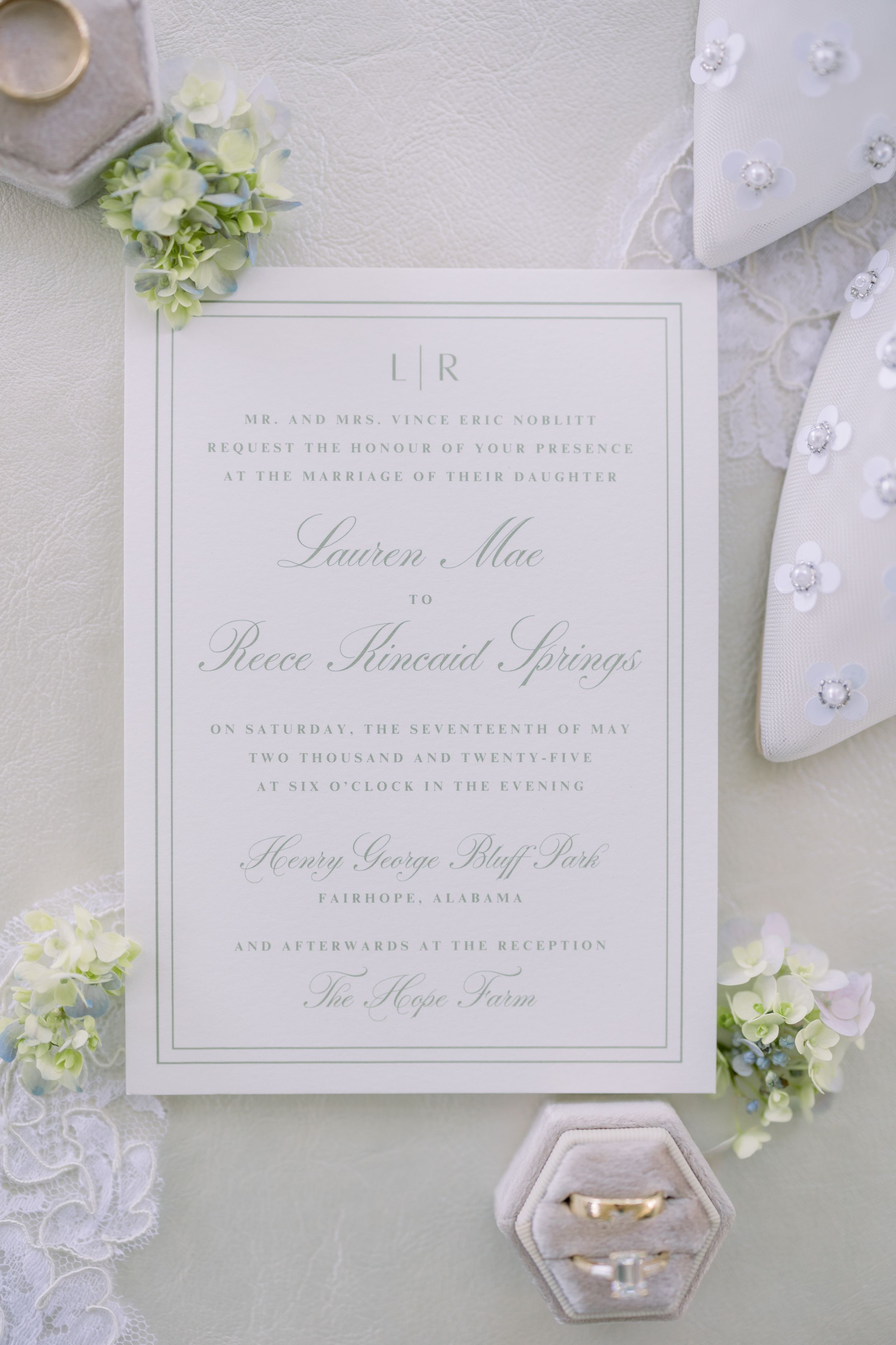Elegant white wedding invitations with floral accents and calligraphy.