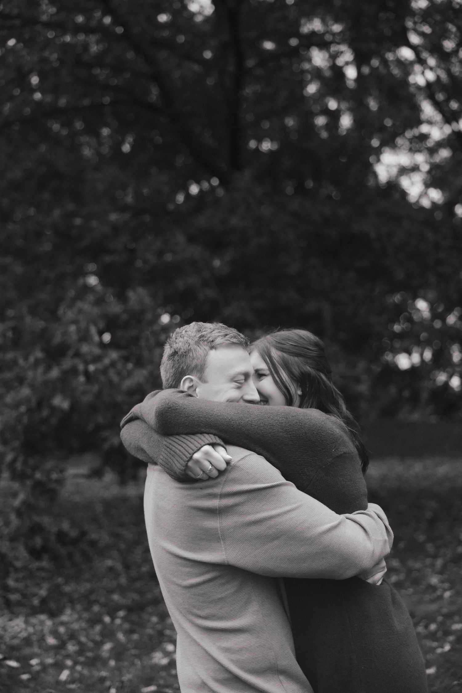 A black and white photo sequence showing two people embracing emotionally in a wooded outdoor setting.