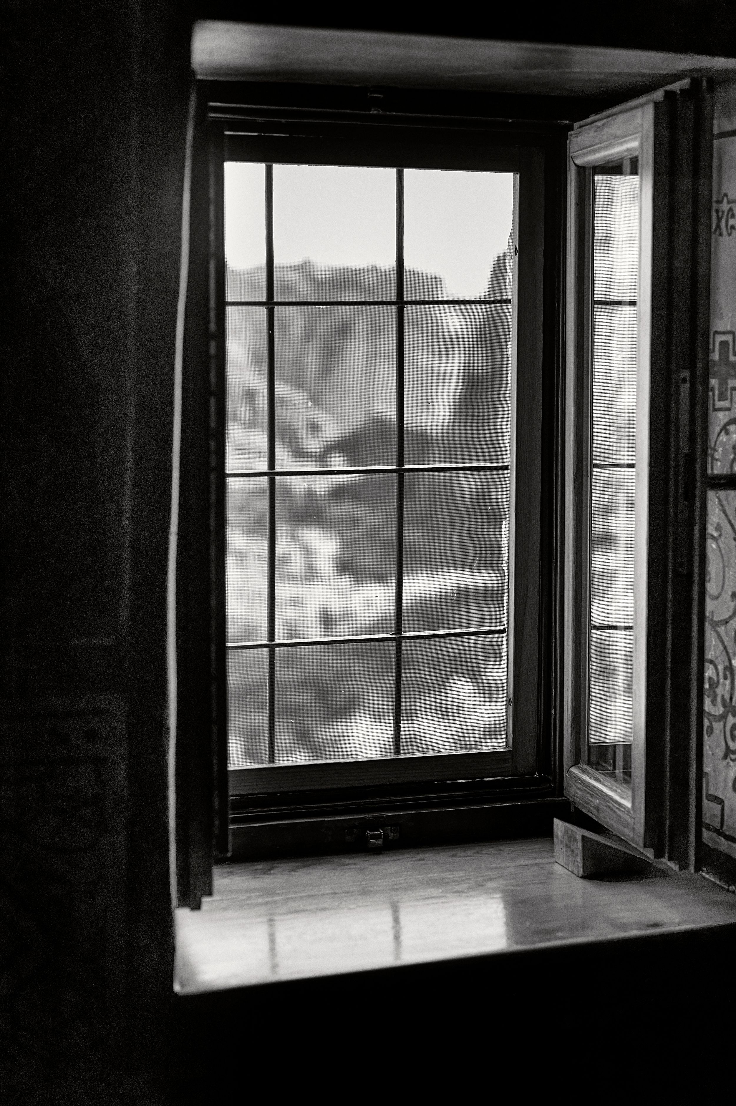 Dramatic black and white interior shots showing sunlight and shadows cast through windows in an empty room.