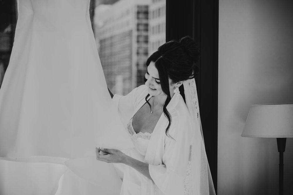 Black and white wedding photo series showing tender moments between a bride and groom during their special day.