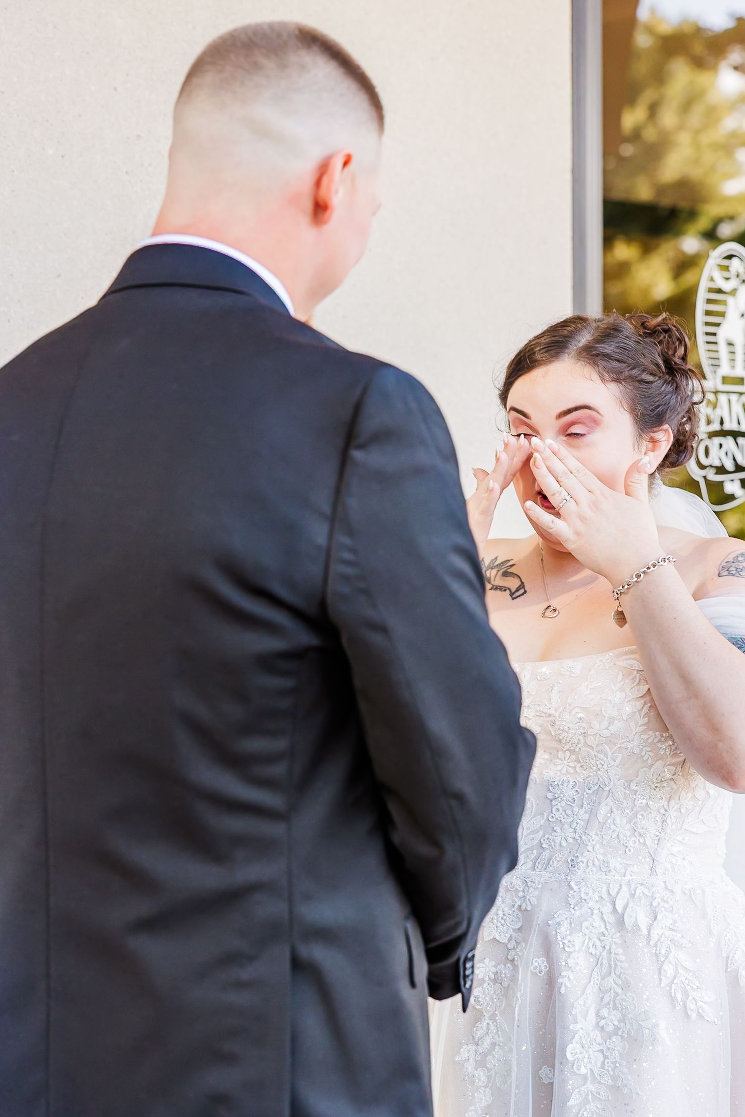 A touching wedding moment captured in a series of photos showing emotional reactions during a first look reveal.
