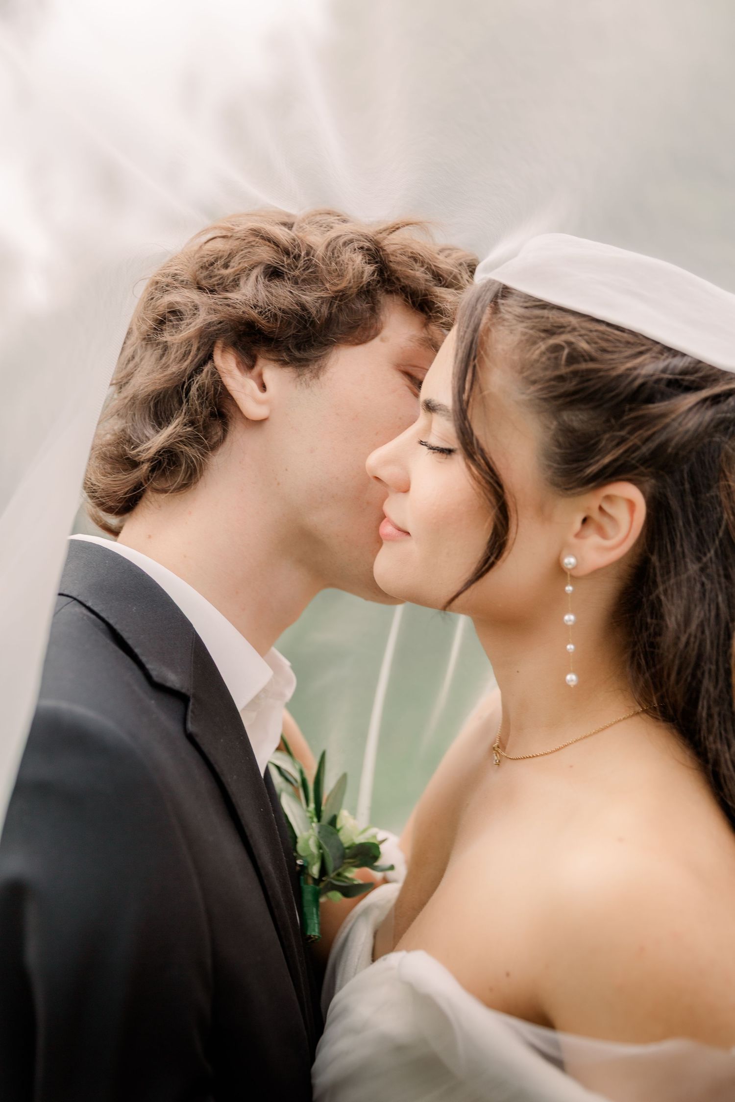 Romantic close-up sequence of a couple sharing tender kisses in formal wedding attire.