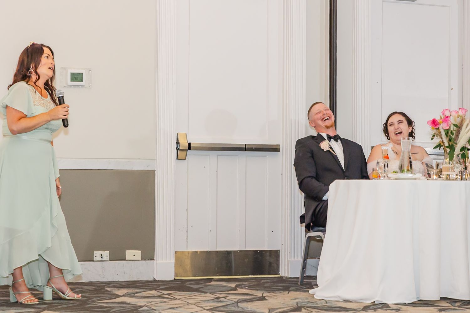 Wedding reception guests dance and celebrate on the dance floor during an elegant indoor celebration.