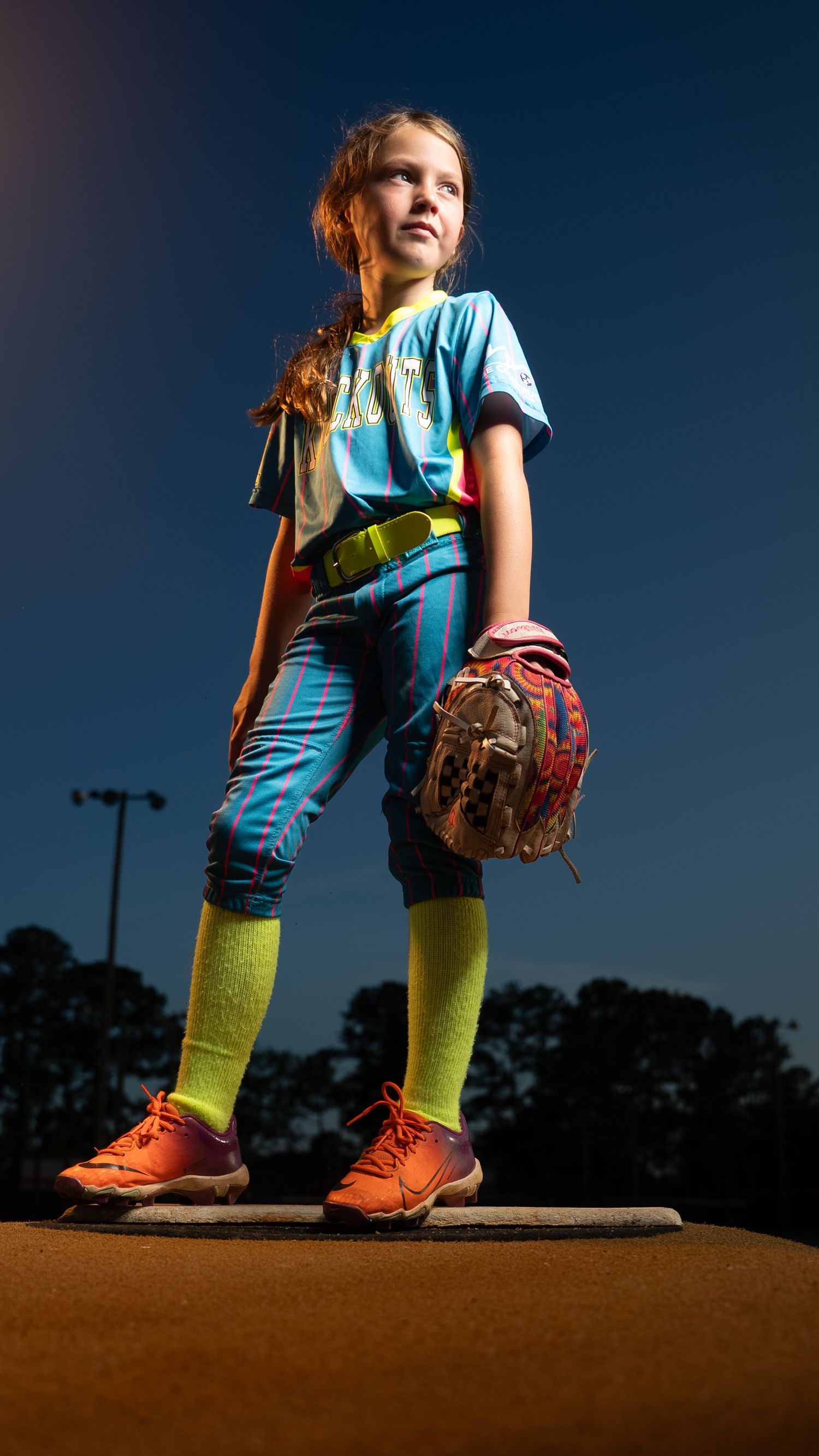 A series of low-angle shots showing bright yellow leggings and orange shoes against a dark evening sky.