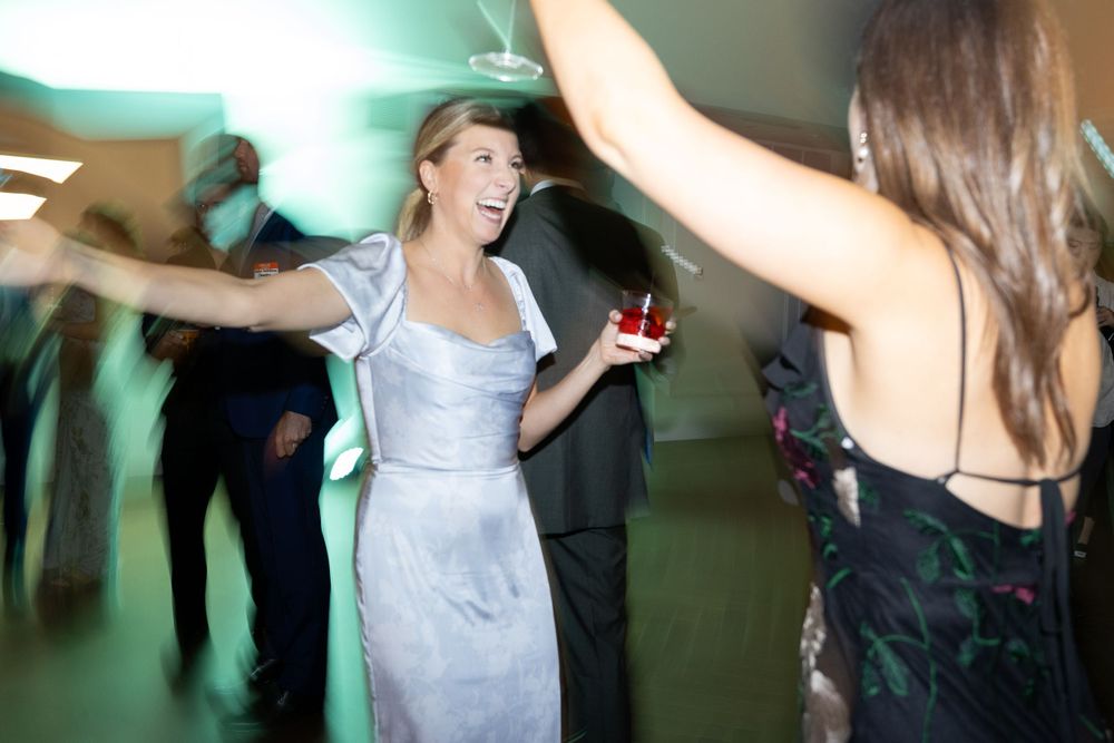 People dancing and having fun at an evening party with motion blur and festive lighting effects.