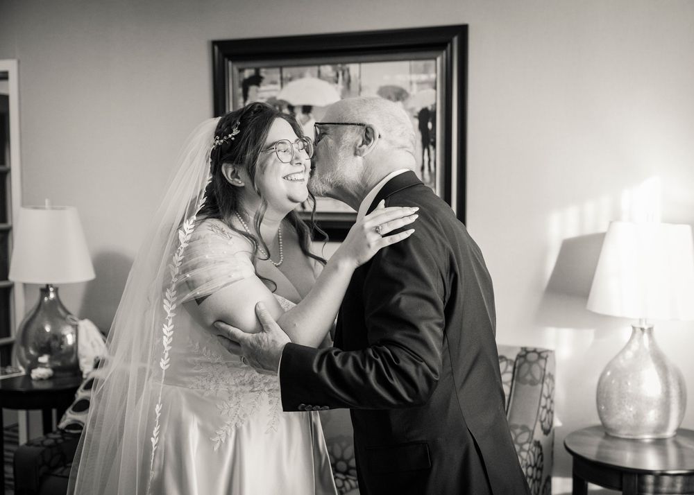A series of black and white wedding photos showing tender moments between a couple during their celebration.