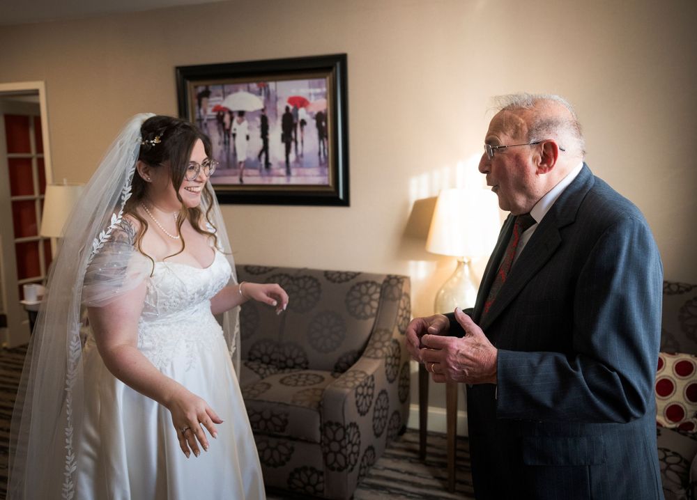 A series of candid wedding moments captured in a soft sepia tone showing interactions between guests and the bride.
