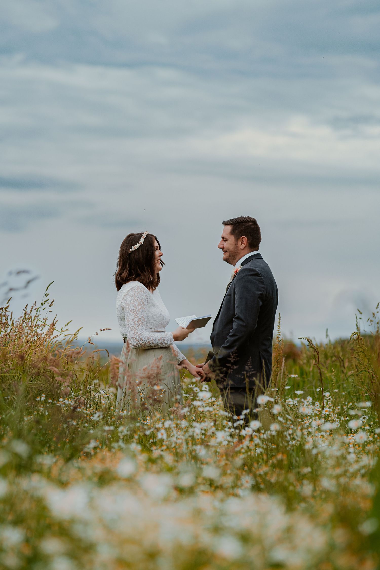 A black and white photo sequence shows a couple sharing a romantic kiss outdoors in a natural setting.