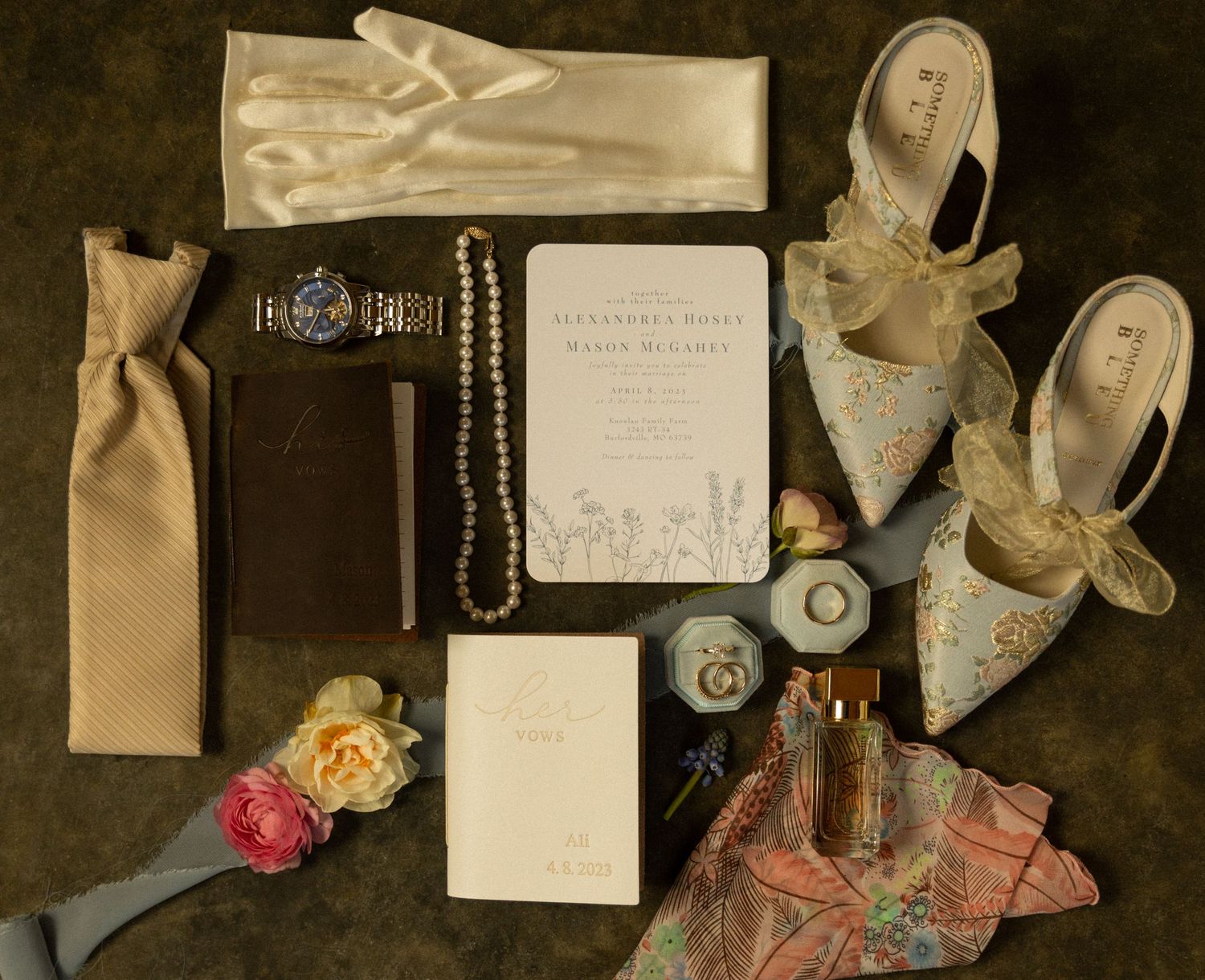 Wedding day accessories including shoes, jewelry, perfume and stationery arranged in flat lay style.