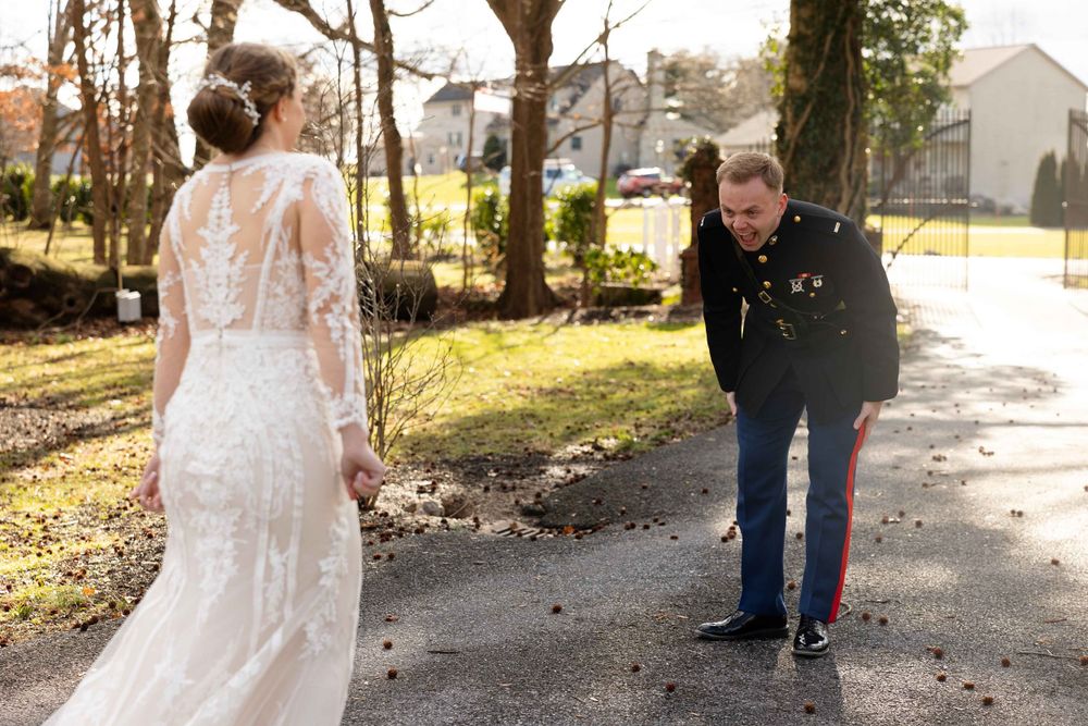 A wedding moment captured outdoors with sunlight streaming through bare winter trees.