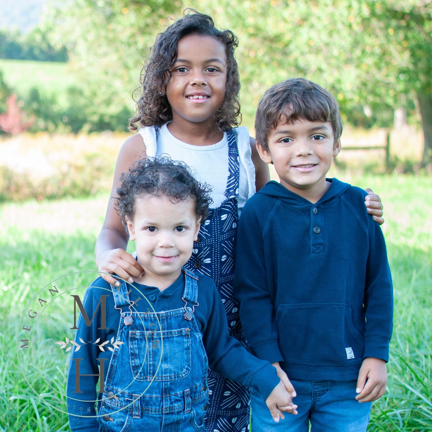 Three kids standing pose smiling